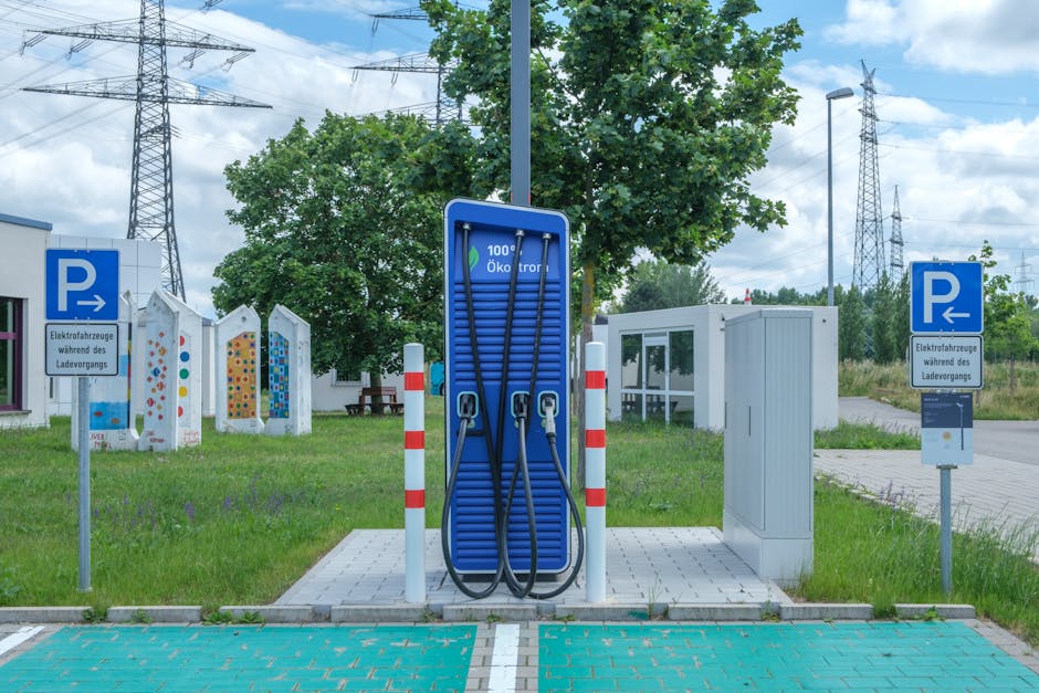 Electric car plugged into a workplace charging station in a UK office car park