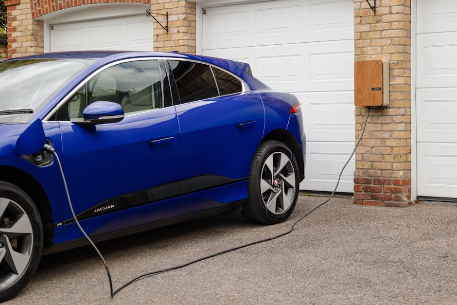 Electric vehicle charging at home overnight with the cable plugged into a wall-mounted charger