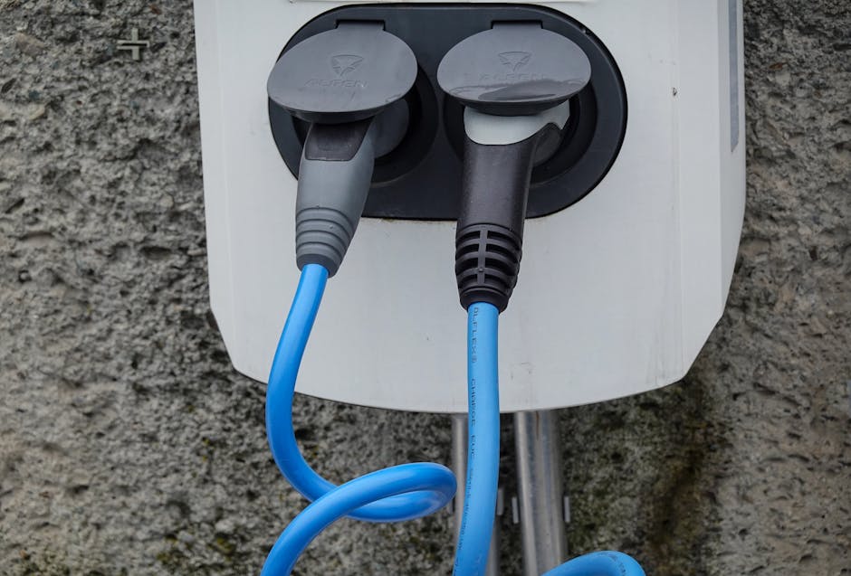 Electric vehicle charging cable plugged in at a UK home charger