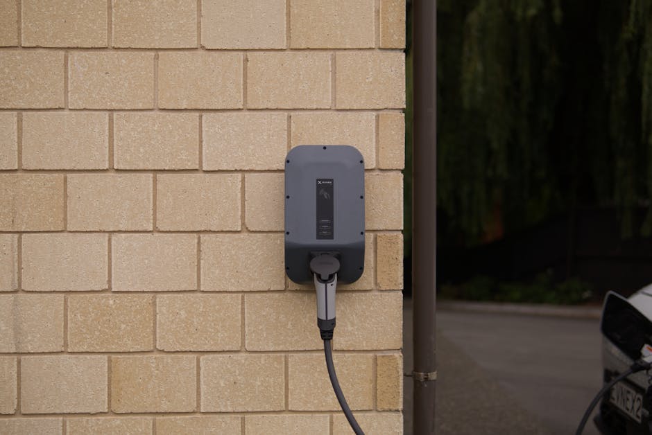 Electrician installing a wall-mounted home EV charger