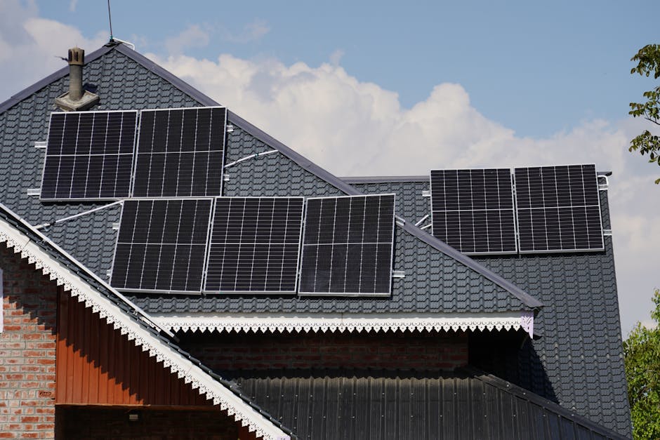 Rooftop solar panels on a UK detached home generating electricity in afternoon sunlight